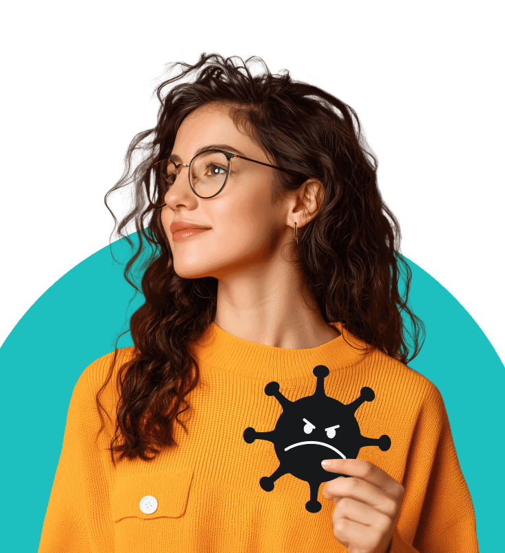 A woman with curly brown hair and glasses in an orange jumper holding an illustrated virus with an angry face on it.