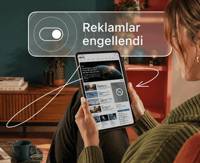 Bir kişi elinde bir tablet tutarken katmanda bir açma/kapatma anahtarı ve Reklamlar engellendi metni gösteriliyor.