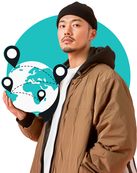 A man wearing a black beanie and brown jacket holding a globe with location markers connected by dotted lines.
