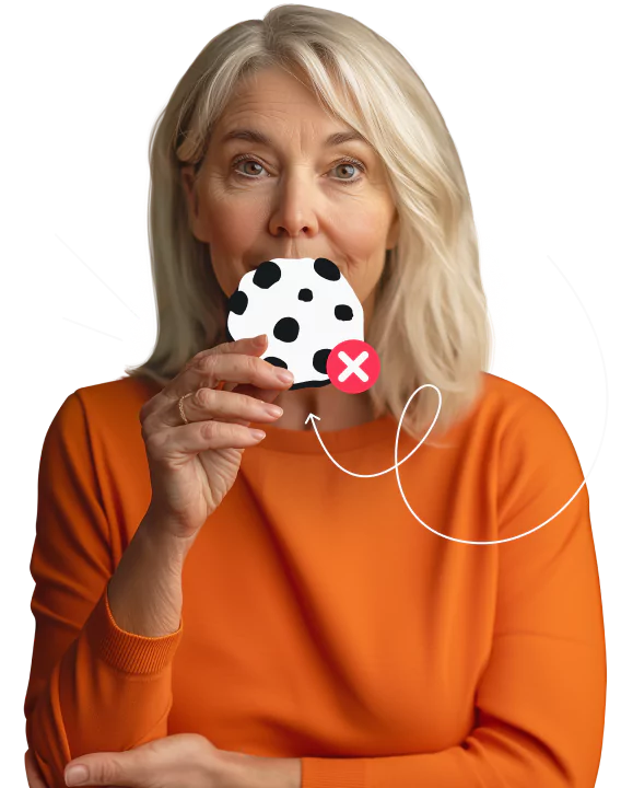 A gray haired woman in a sweater holding an illustrated cookie marked with a red X, impact lines, and a squiggly arrow.
