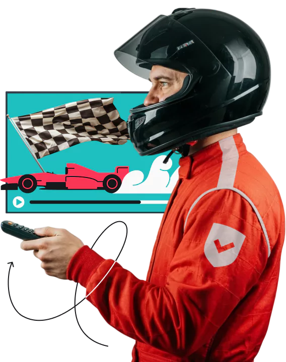 Un homme portant un casque noir et une combinaison de course rouge tient une télécommande à côté d'un écran affichant un drapeau à damier et une voiture de Formule 1 rouge.
