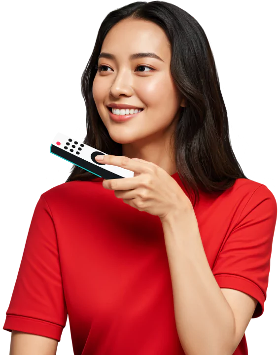 A smiling woman with long dark hair in a red shirt holding a remote control while looking slightly to the side.
