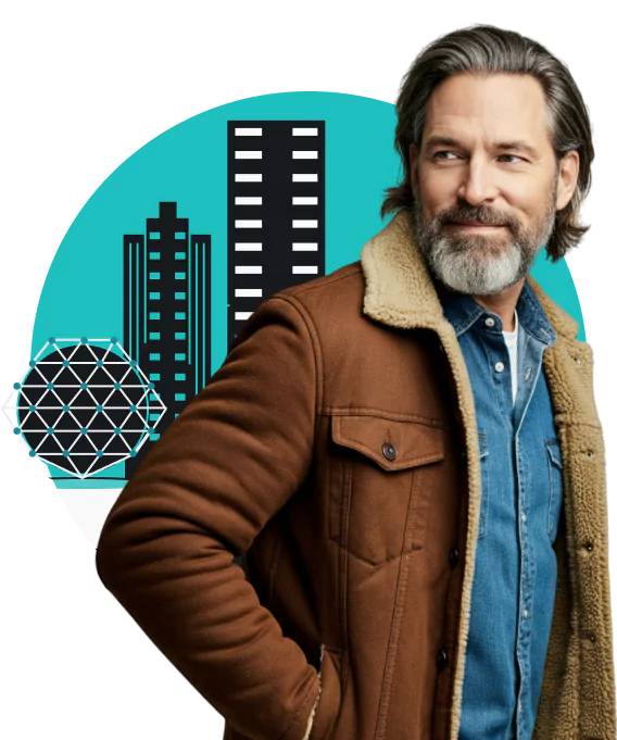 A bearded man wearing a brown sherpa jacket and denim shirt standing in front of two skyscrapers and a geodesic dome.