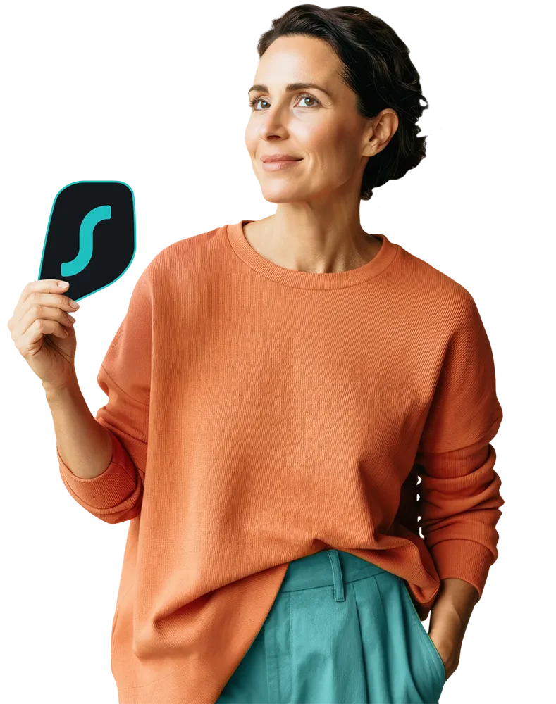 A woman in an orange sweater holding the Surfshark logo standing against a split black and teal background.